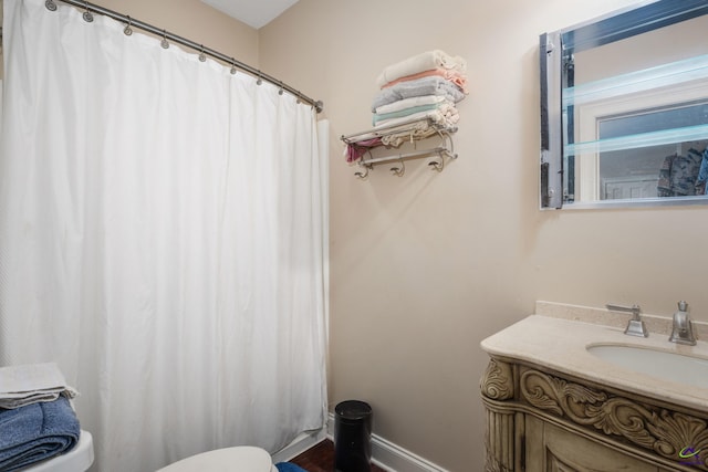 bathroom with toilet and vanity