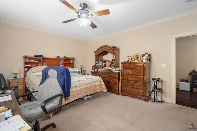 carpeted bedroom with ornamental molding and ceiling fan