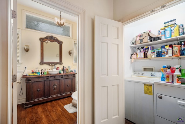 interior space with an inviting chandelier, hardwood / wood-style floors, toilet, independent washer and dryer, and vanity