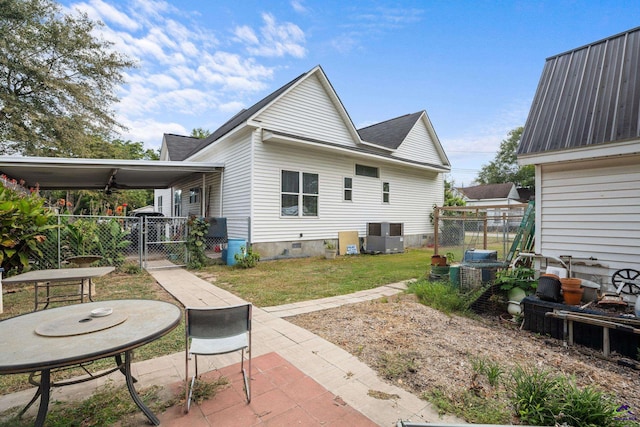 rear view of property with a yard and cooling unit