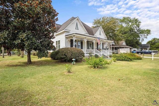 view of side of home with a yard and a porch