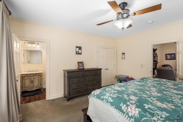 bedroom with a closet, carpet floors, ensuite bath, ornamental molding, and ceiling fan