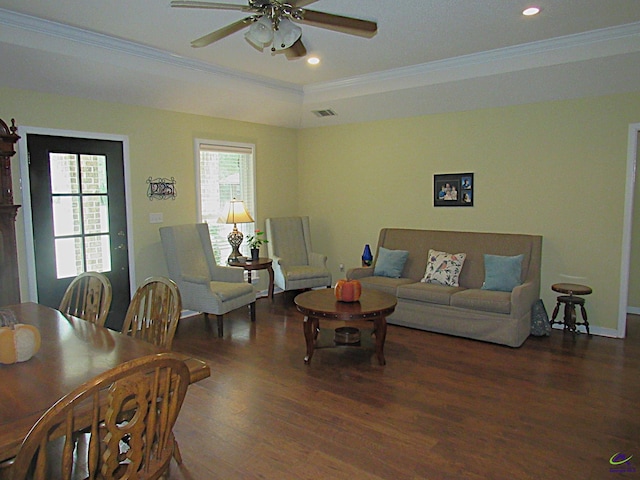 living room with ornamental molding, dark hardwood / wood-style flooring, and ceiling fan