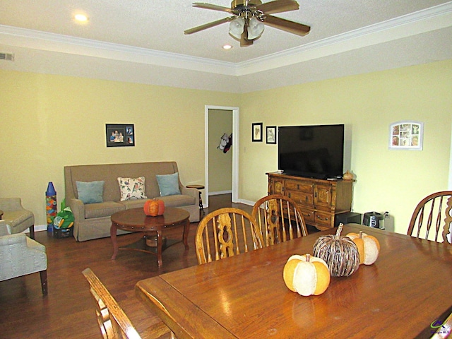 dining space with ceiling fan, a textured ceiling, dark hardwood / wood-style floors, and ornamental molding