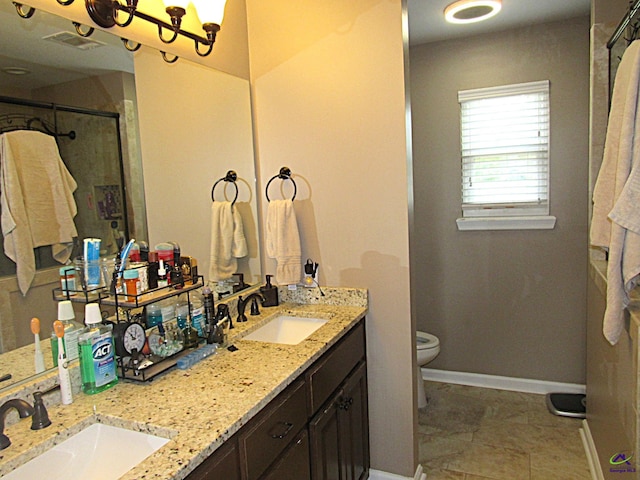 bathroom with walk in shower, vanity, and toilet