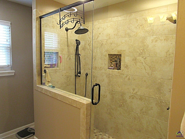 bathroom with a shower with door