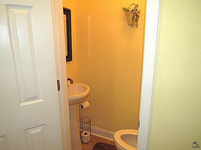 bathroom featuring tile patterned flooring and toilet