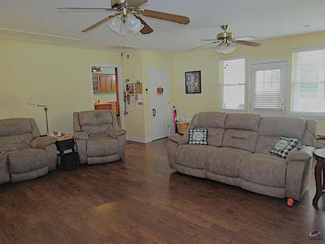 living room featuring ceiling fan and dark hardwood / wood-style floors