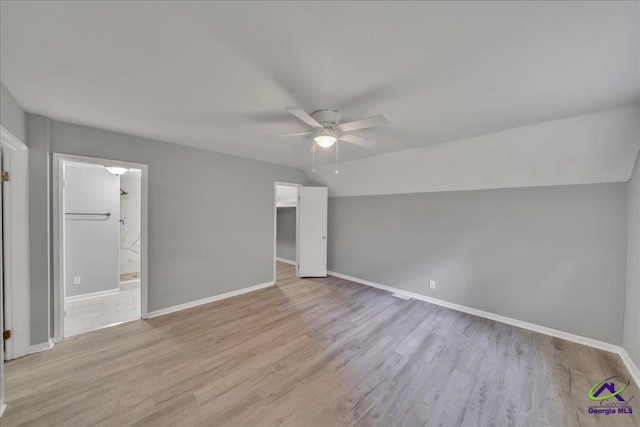 unfurnished bedroom with ensuite bathroom, light wood-type flooring, and ceiling fan