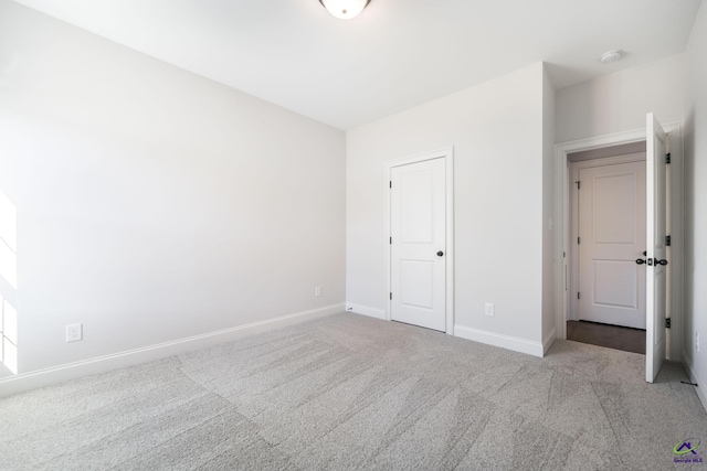 unfurnished bedroom with light colored carpet