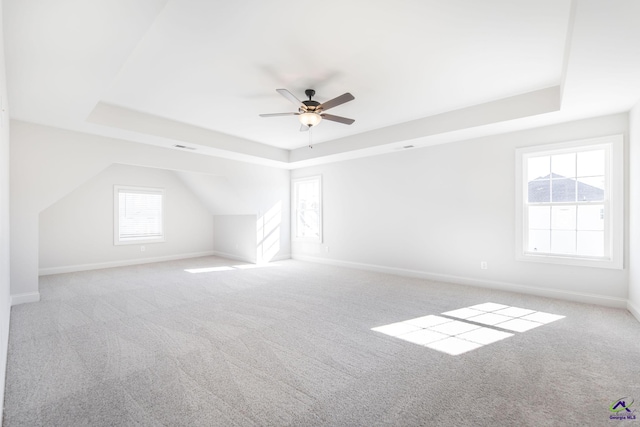 additional living space featuring light carpet and ceiling fan