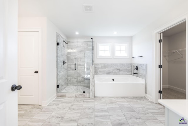 bathroom featuring independent shower and bath