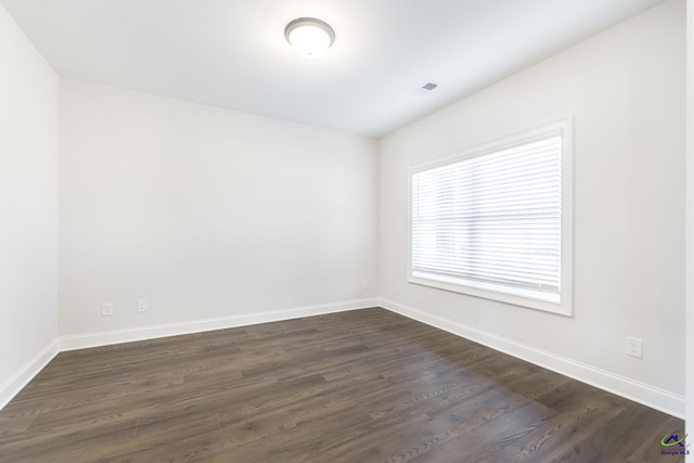 unfurnished room featuring dark hardwood / wood-style flooring