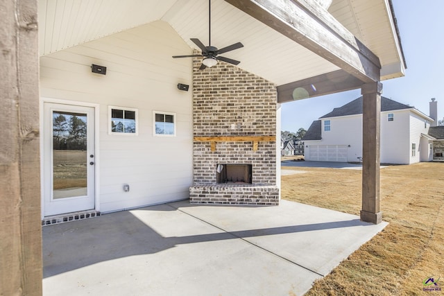 view of patio / terrace featuring ceiling fan and an outdoor brick fireplace