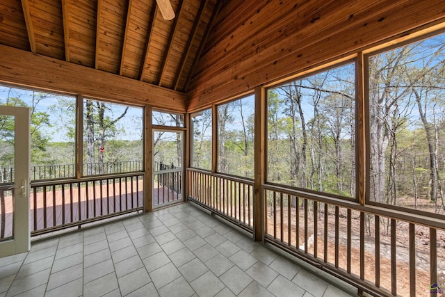 unfurnished sunroom with lofted ceiling with beams and wood ceiling