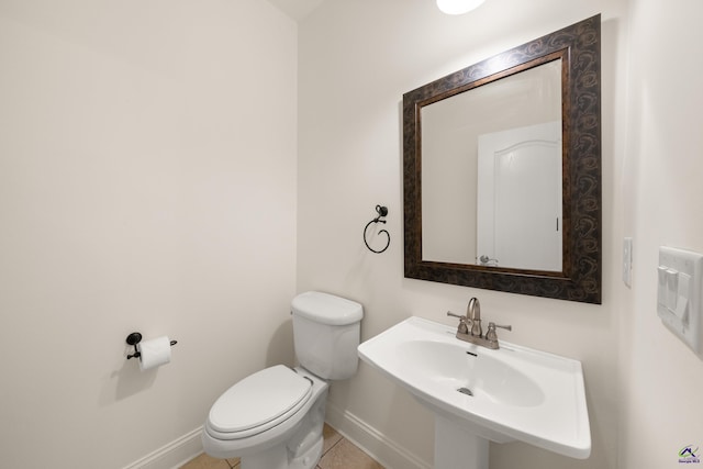 bathroom featuring tile patterned flooring, toilet, and sink