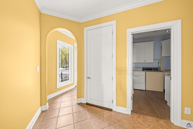 interior space featuring ornamental molding, separate washer and dryer, and light tile patterned flooring