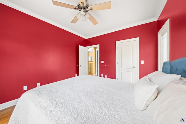 bedroom featuring ceiling fan, crown molding, and wood-type flooring