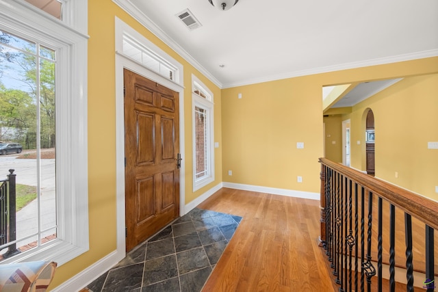 entrance foyer featuring dark hardwood / wood-style floors and crown molding