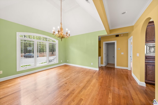 unfurnished room with wood-type flooring, an inviting chandelier, crown molding, and vaulted ceiling