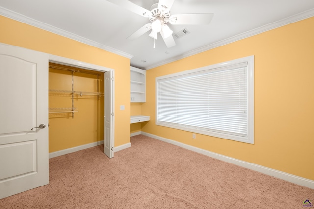 unfurnished bedroom with light carpet, a closet, ceiling fan, and crown molding