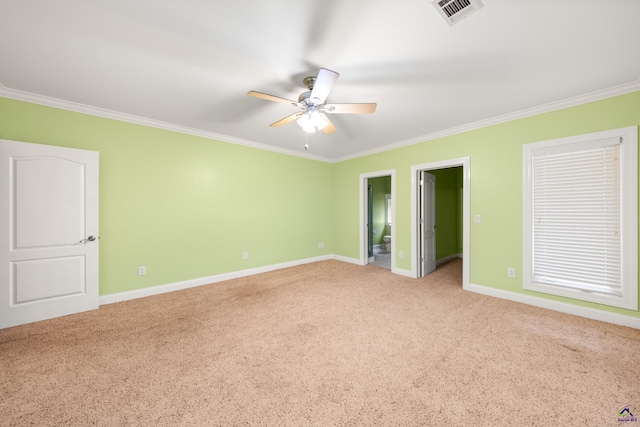 unfurnished bedroom with connected bathroom, ornamental molding, carpet floors, and ceiling fan