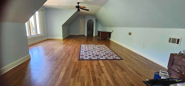 additional living space featuring vaulted ceiling, ceiling fan, and dark hardwood / wood-style floors