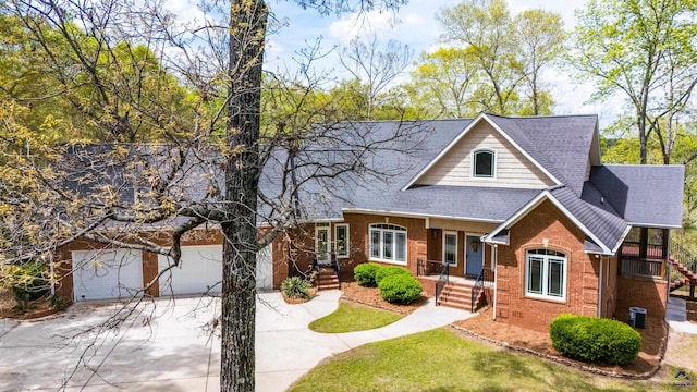 view of front of property with cooling unit, a garage, and a porch