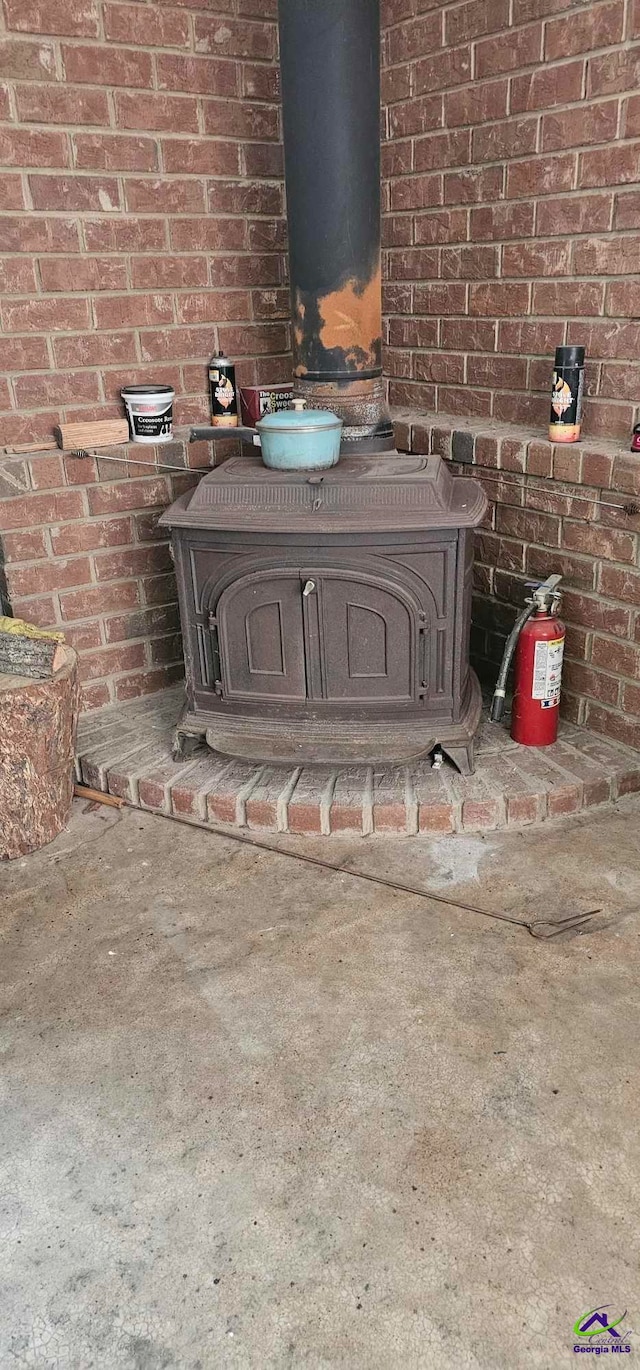 interior details featuring concrete flooring and a wood stove