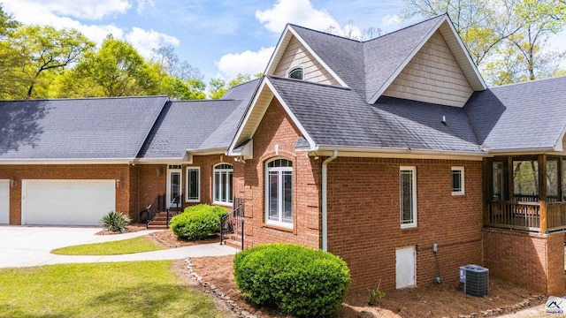 view of front of home with central AC and a garage