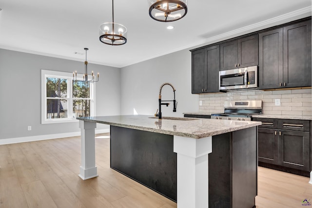 285 Lakeview Dr, Macon, GA 31211 - kitchen featuring appliances with stainless steel finishes, a sink, a chandelier, light stone countertops, and backsplash