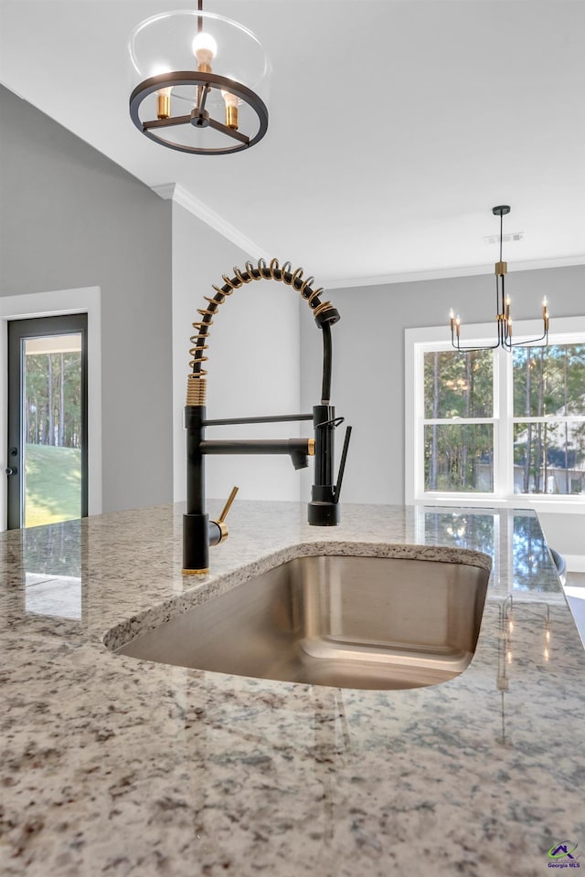 285 Lakeview Dr, Macon, GA 31211 - kitchen view of a chandelier, a sink, crown molding, light stone countertops, and decorative light fixtures