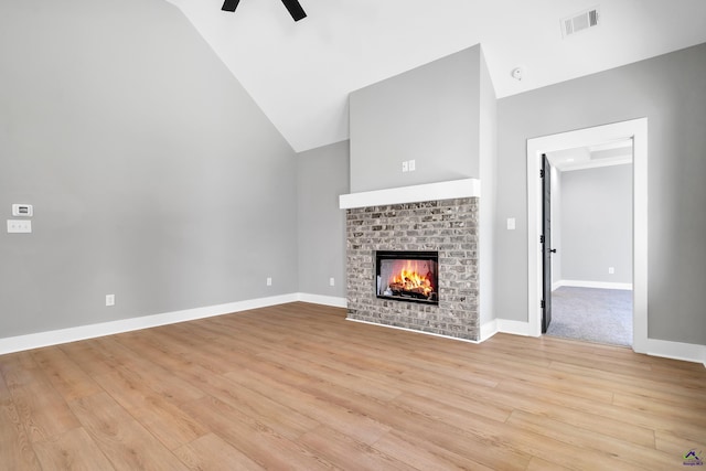 285 Lakeview Dr, Macon, GA 31211 - unfurnished living room featuring ceiling fan, light wood-style floors, a brick fireplace, baseboards, and high vaulted ceiling