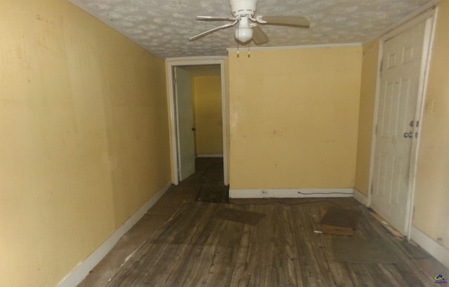 spare room with ceiling fan, dark hardwood / wood-style floors, and a textured ceiling