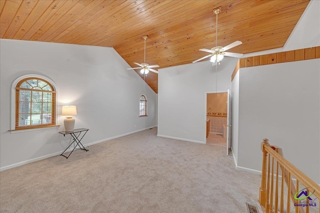 carpeted spare room featuring high vaulted ceiling, ceiling fan, and wood ceiling