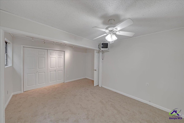 unfurnished bedroom with light carpet, ceiling fan, and a closet