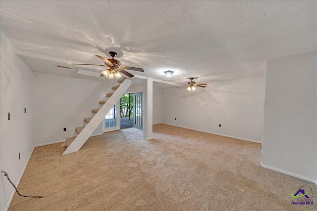 interior space with ceiling fan and a textured ceiling