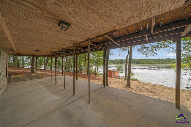 view of patio / terrace featuring an outdoor structure and a water view