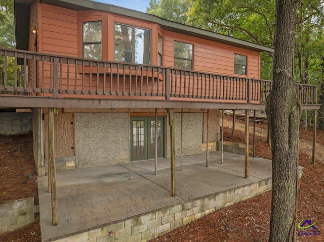 back of property with french doors, a patio area, and a wooden deck