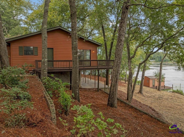 view of yard with a deck with water view