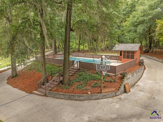 view of front facade with a pool side deck