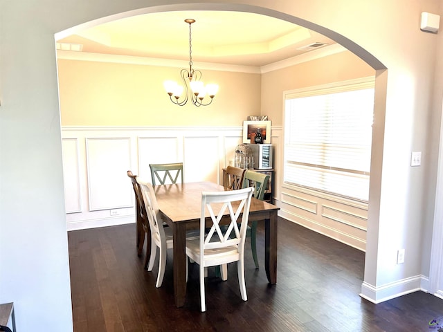 216 Brentfield Drs, Bonaire, GA 31005 - dining room featuring visible vents, dark wood-type flooring, a raised ceiling, a decorative wall, and a chandelier