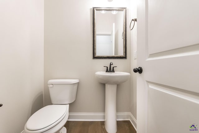 202 Bella Notte Cir, Warner Robins, GA 31088 - bathroom featuring baseboards, toilet, and wood finished floors