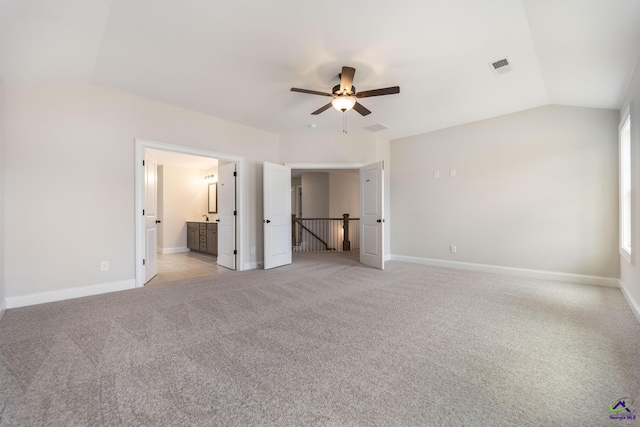 202 Bella Notte Cir, Warner Robins, GA 31088 - unfurnished bedroom featuring baseboards, vaulted ceiling, visible vents, and light colored carpet