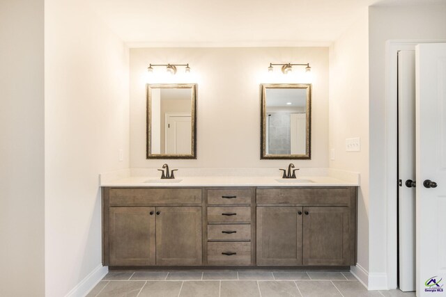 202 Bella Notte Cir, Warner Robins, GA 31088 - bathroom featuring double vanity, tile patterned floors, baseboards, and a sink
