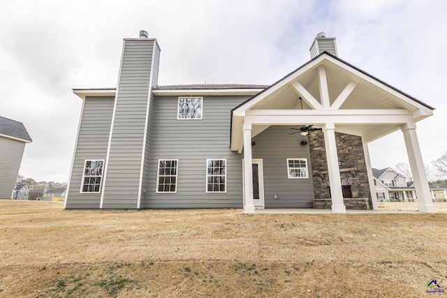 202 Bella Notte Cir, Warner Robins, GA 31088 - rear view of property featuring a ceiling fan, a chimney, and a patio