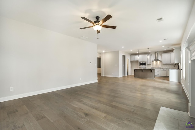 202 Bella Notte Cir, Warner Robins, GA 31088 - unfurnished living room featuring ceiling fan, wood finished floors, visible vents, and recessed lighting
