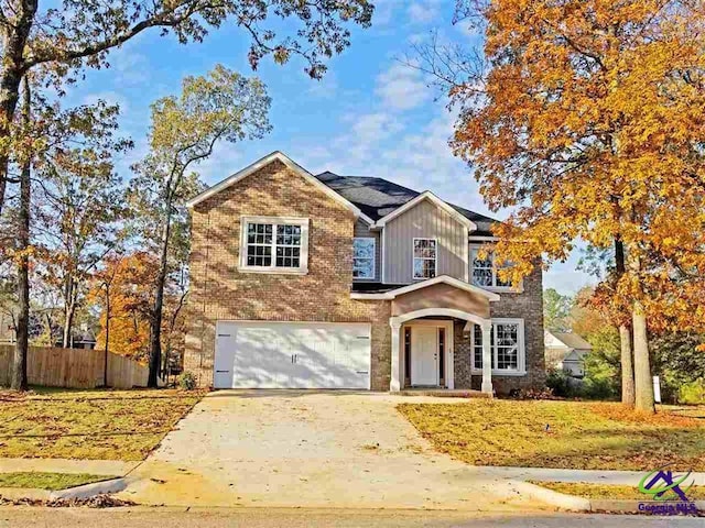 203 Lattice Bnd, Bonaire, GA 31005 - traditional-style home with fence, a garage, concrete driveway, board and batten siding, and brick siding