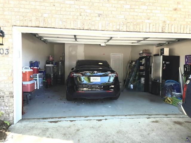 garage with stainless steel refrigerator