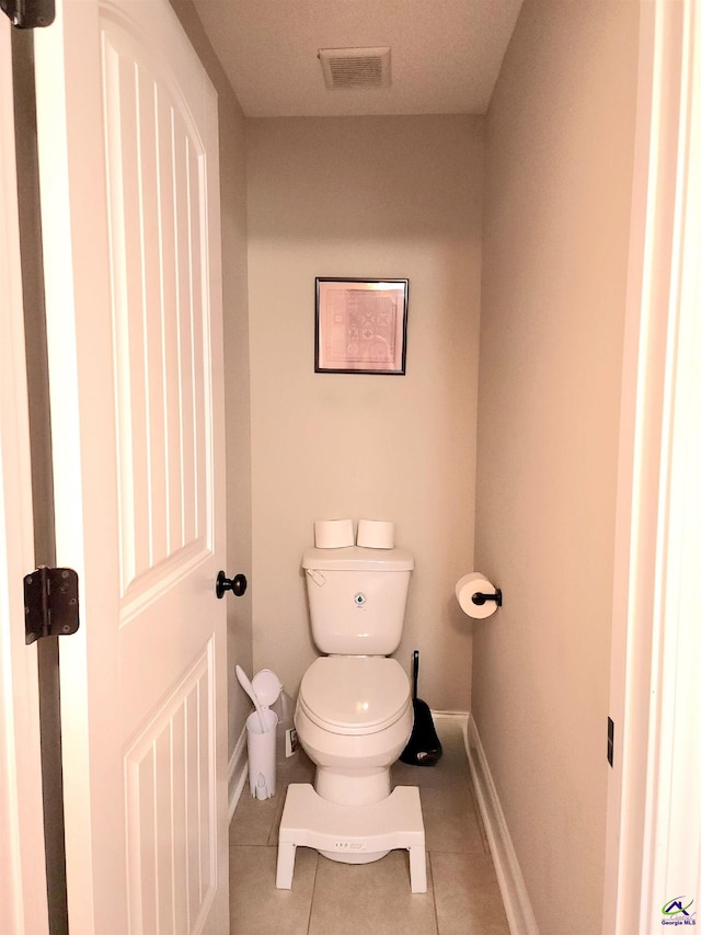 bathroom with tile patterned flooring and toilet